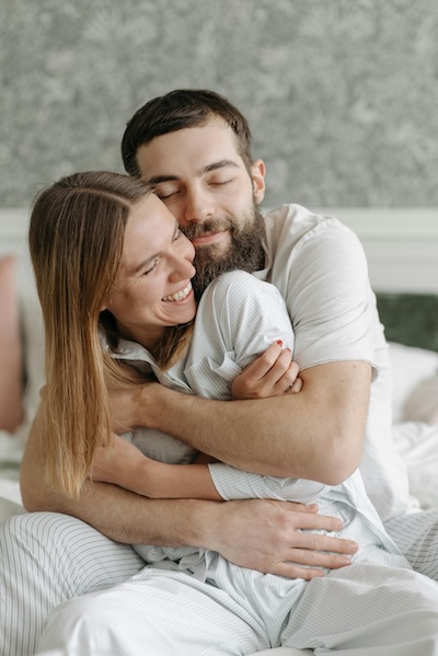 A man hugging a woman