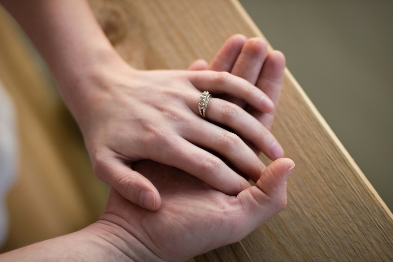 Two hands holding each other