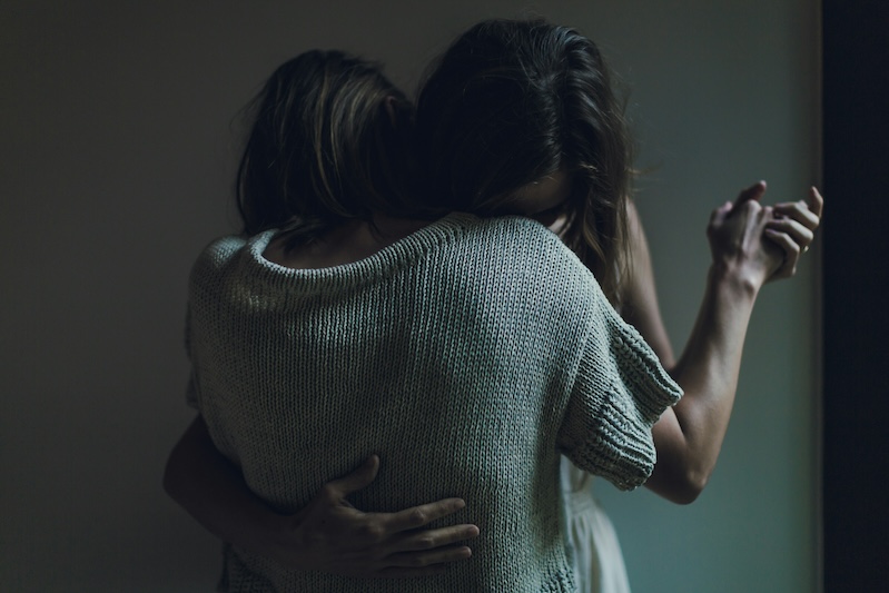 Two people hugging in an embrace