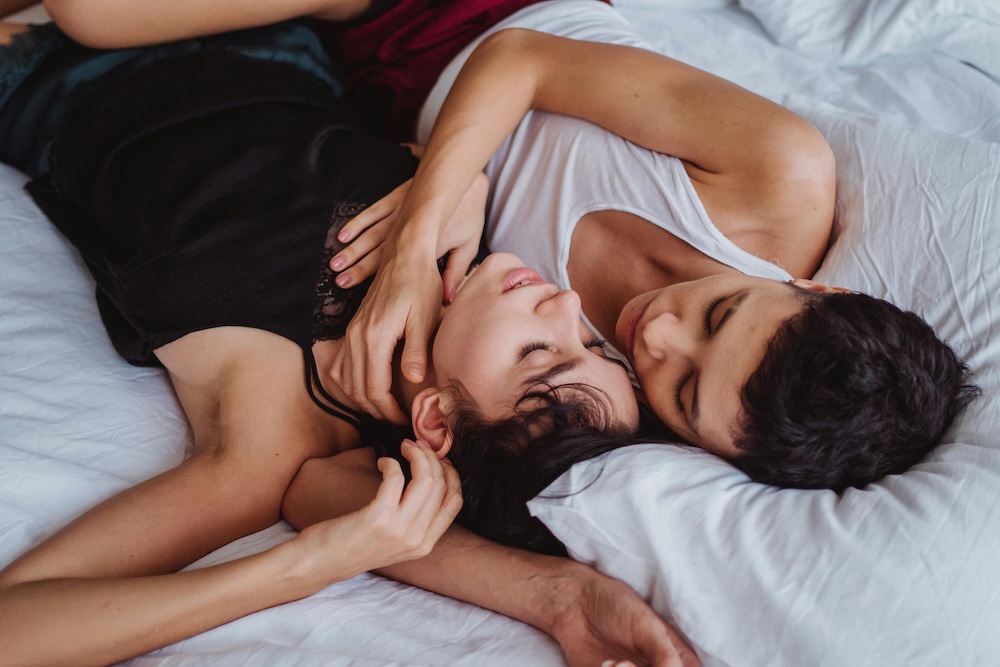 Two people laying down cuddling