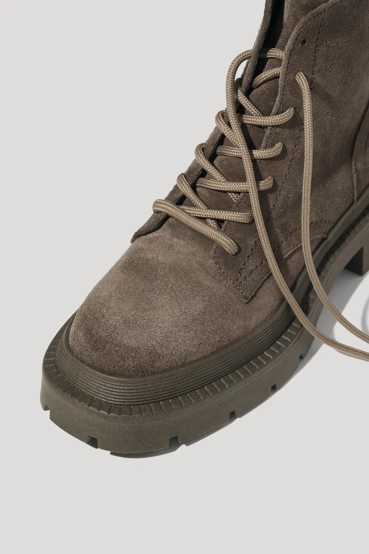 Coffee suede boots on a chunky sole lined with faux fur