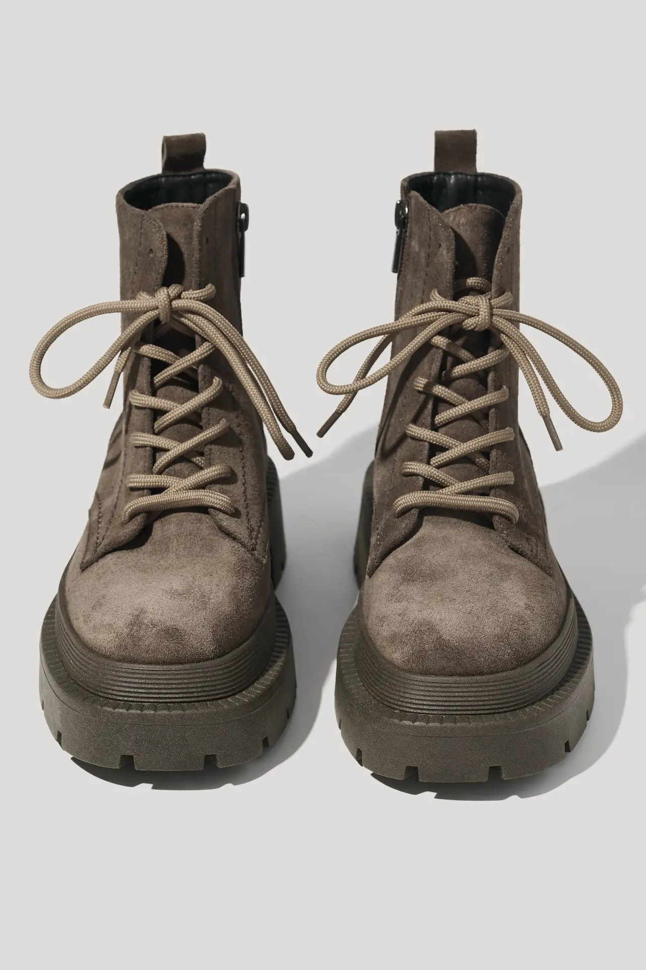 Coffee suede boots on a chunky sole lined with natural fur