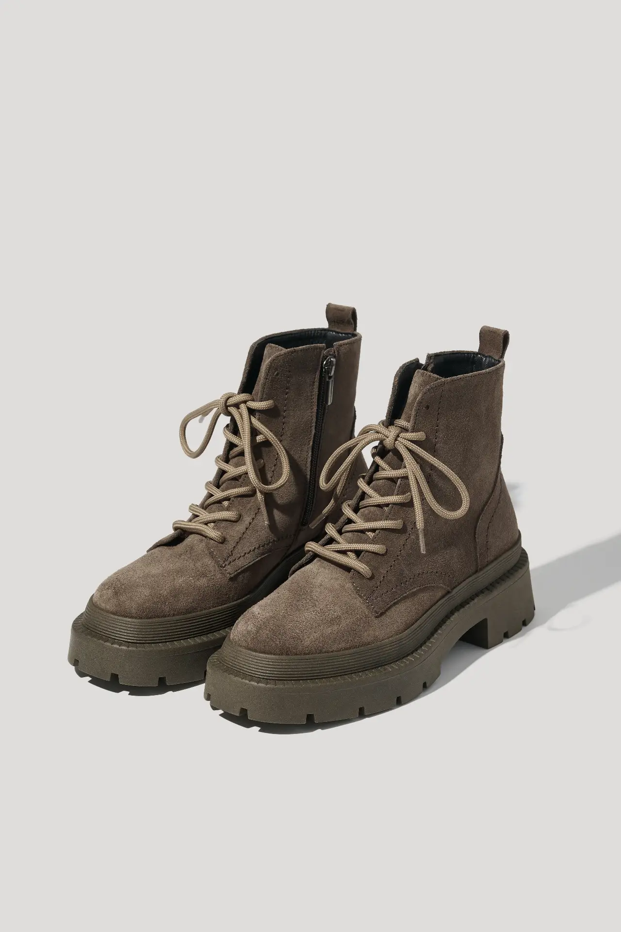 Coffee suede boots on a chunky sole lined with natural fur