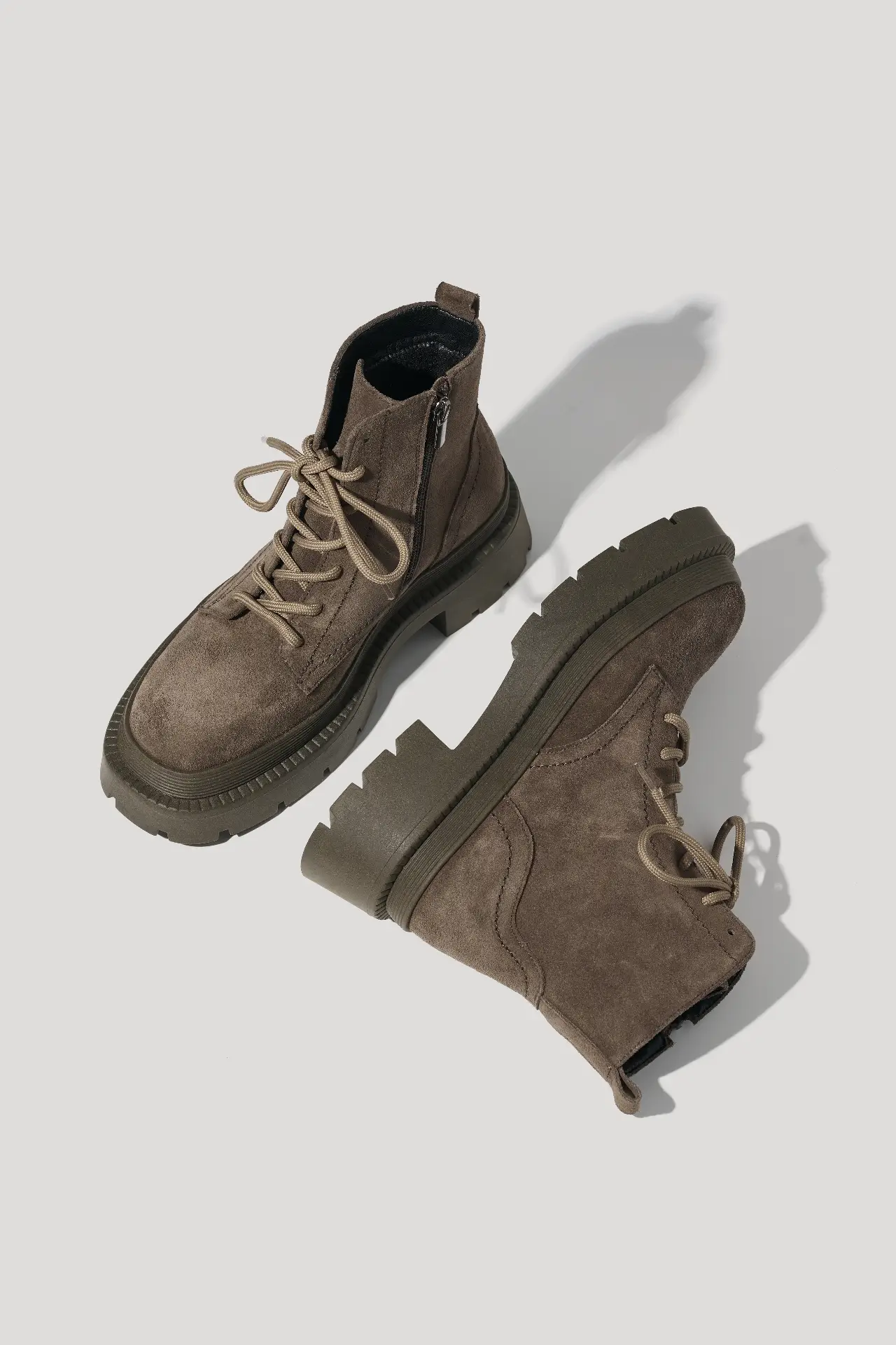 Coffee suede boots on a chunky sole lined with natural fur