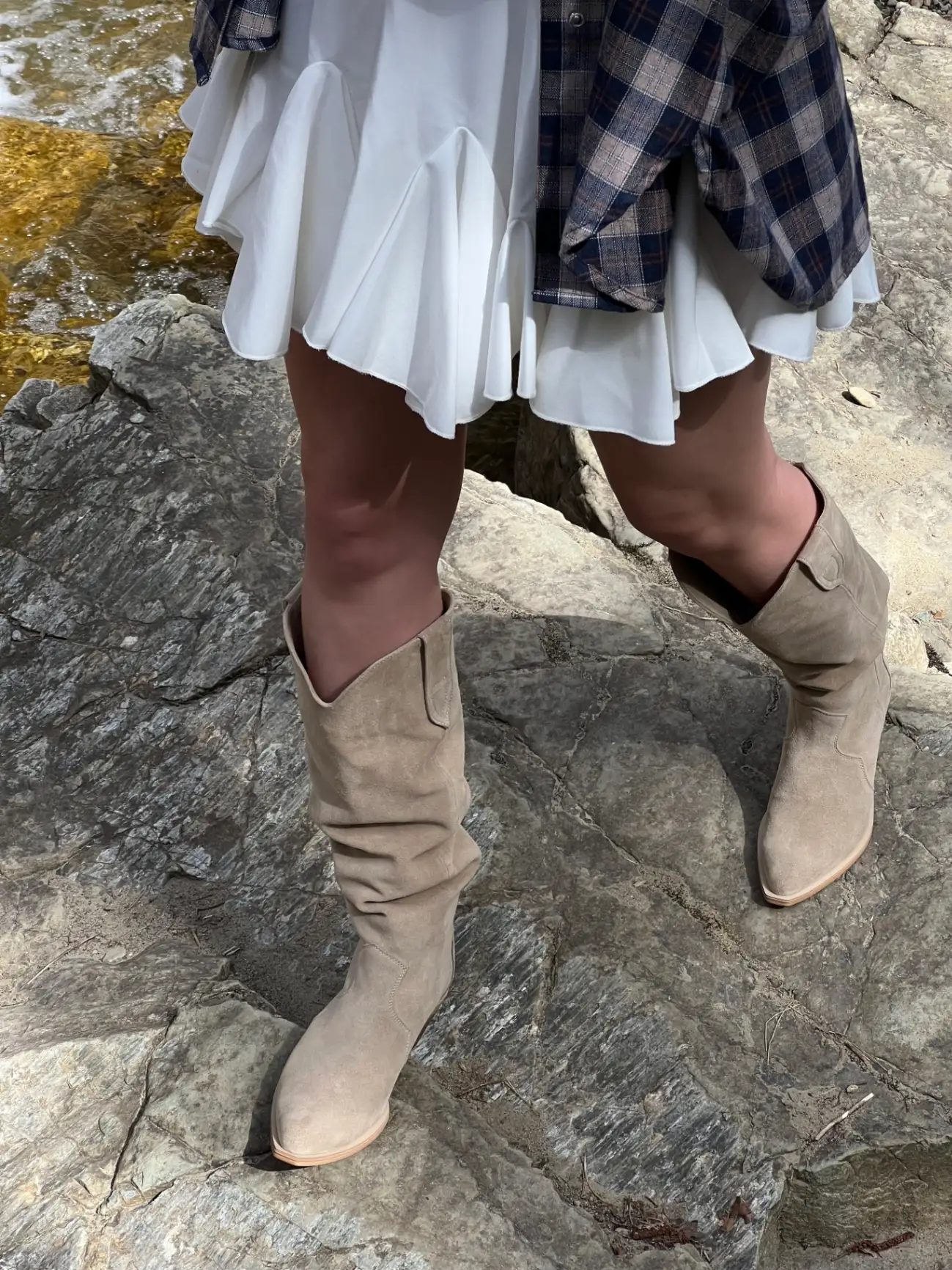 Beige suede cowboy-style boots lined with leather