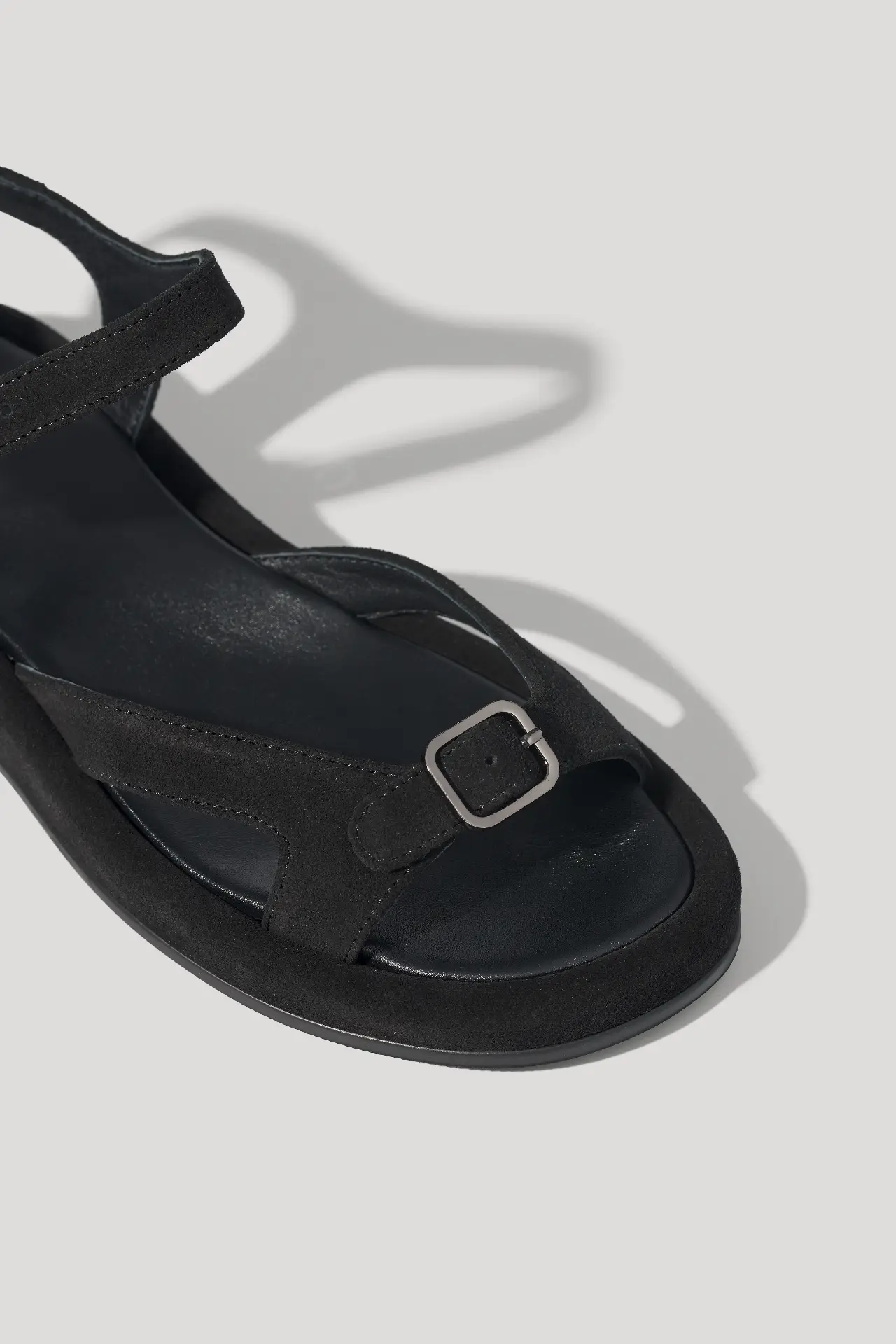 Black suede sandals with an adjustable strap