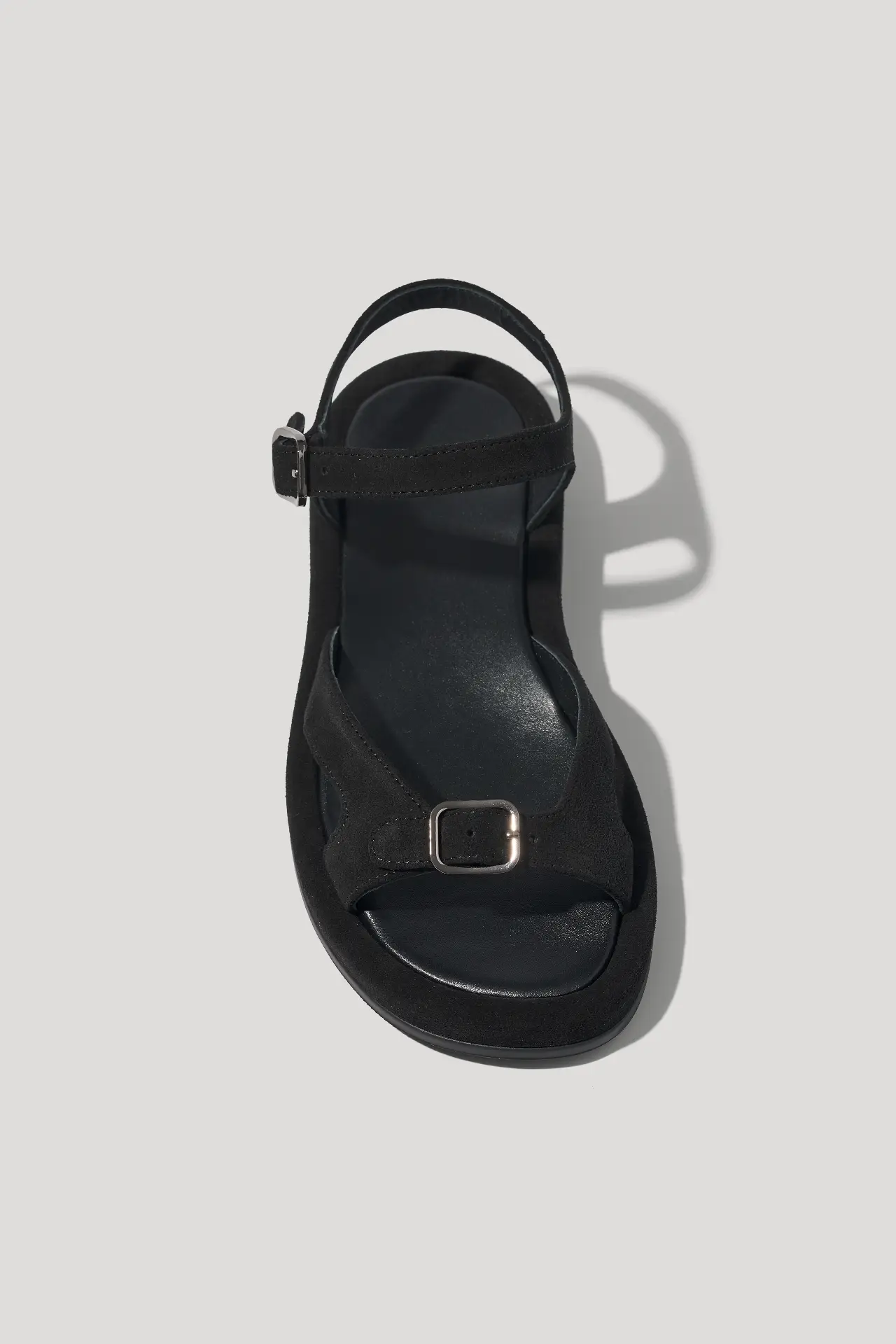 Black suede sandals with an adjustable strap