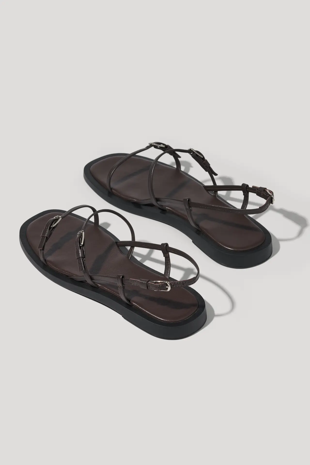 Minimalist black leather sandals with slim straps
