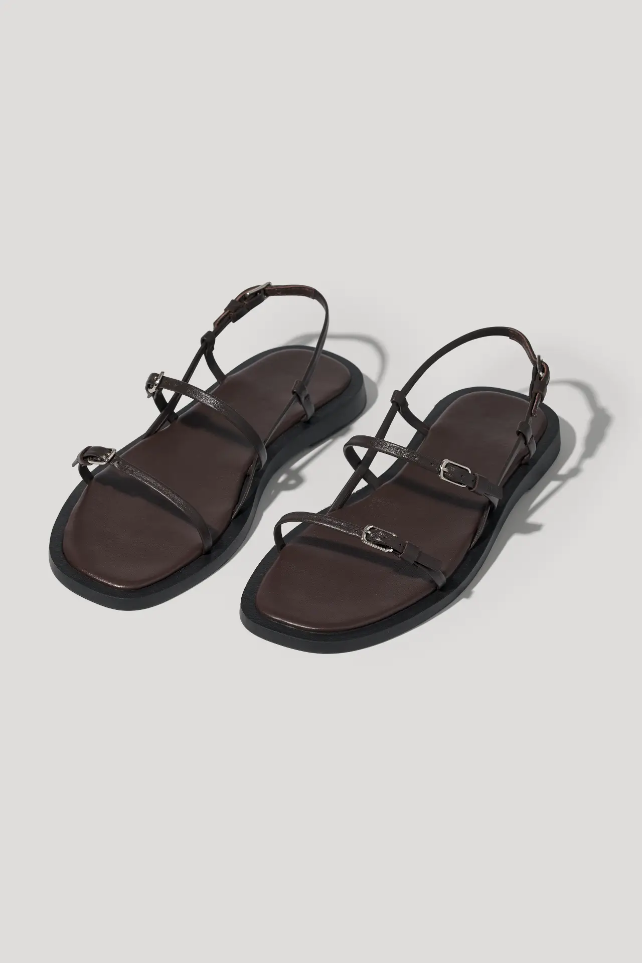 Minimalist black leather sandals with slim straps