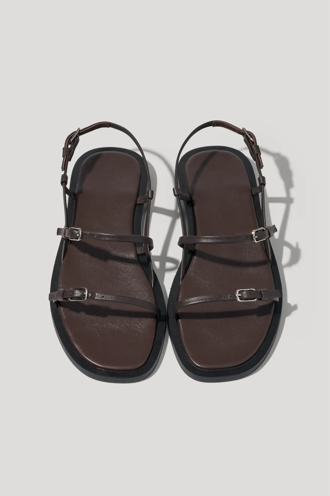 Minimalist black leather sandals with slim straps
