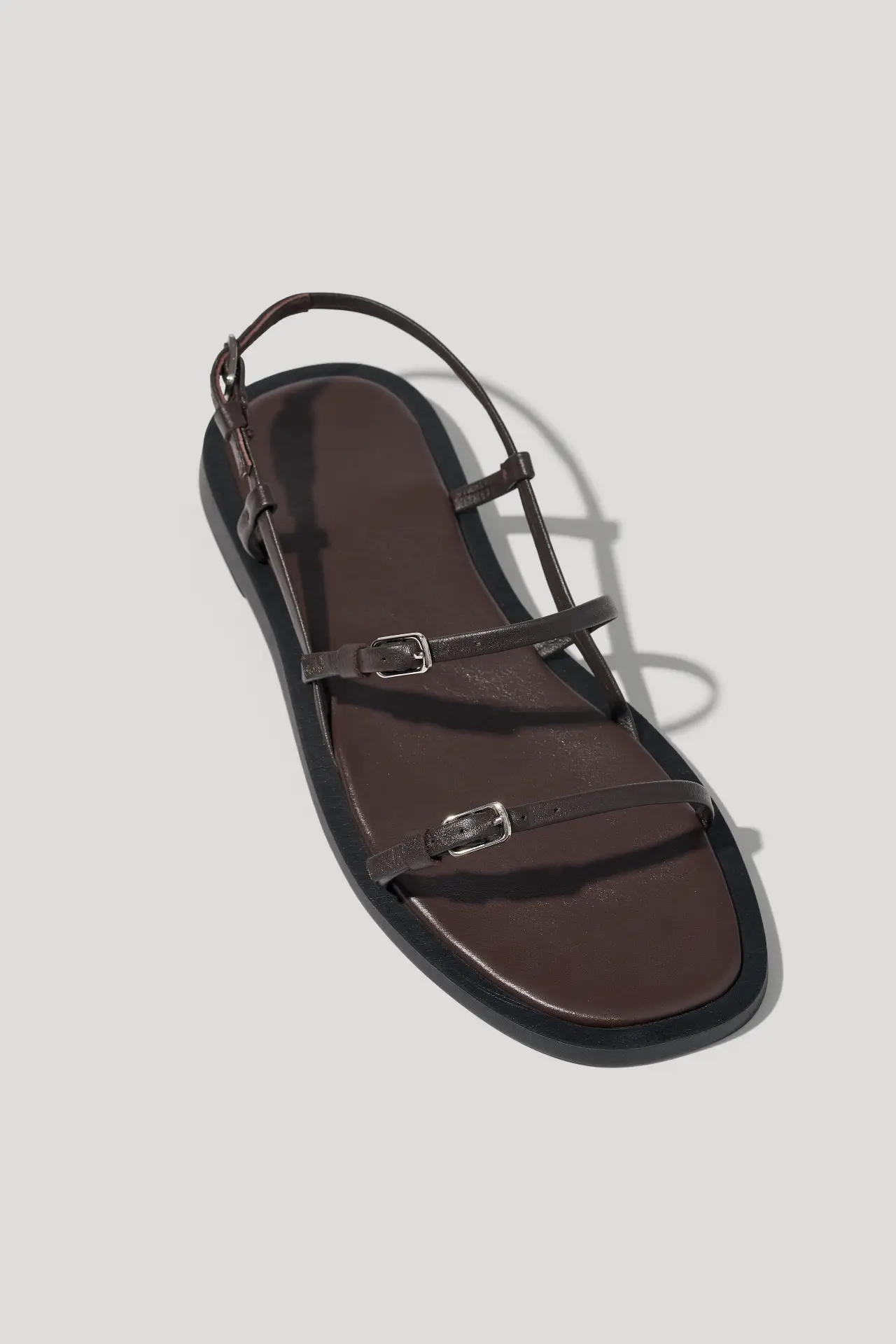 Minimalist black leather sandals with slim straps