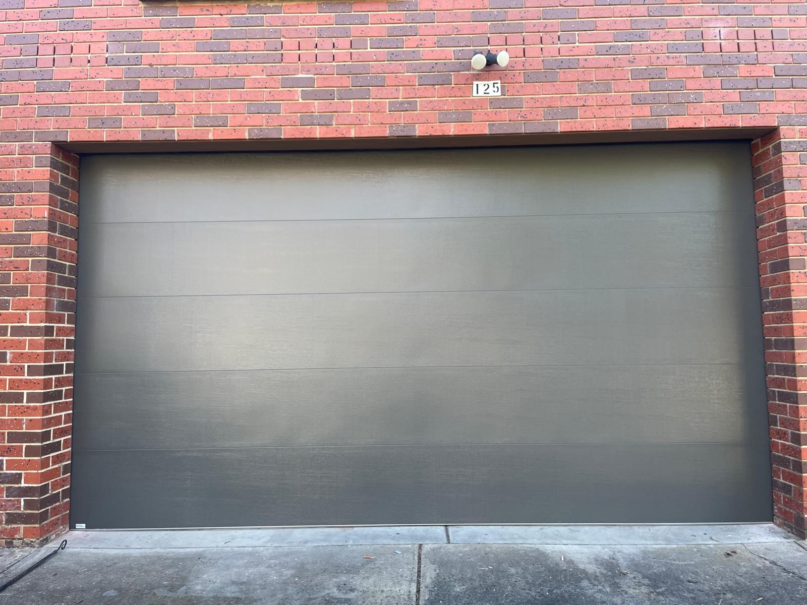 A repaired sectional door panel looking brand new.