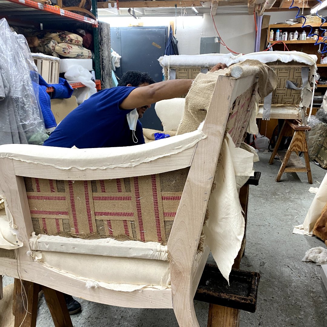 Reupholstering and crafting a custom-made lounge chair in the Era Interiors upholstery workshop.