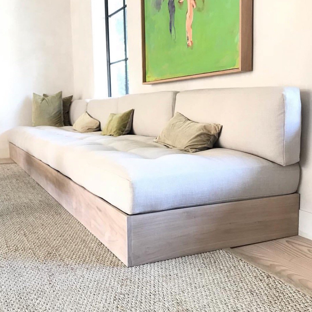 Bespoke dining banquette upholstery with integrated wood base and custom pillows