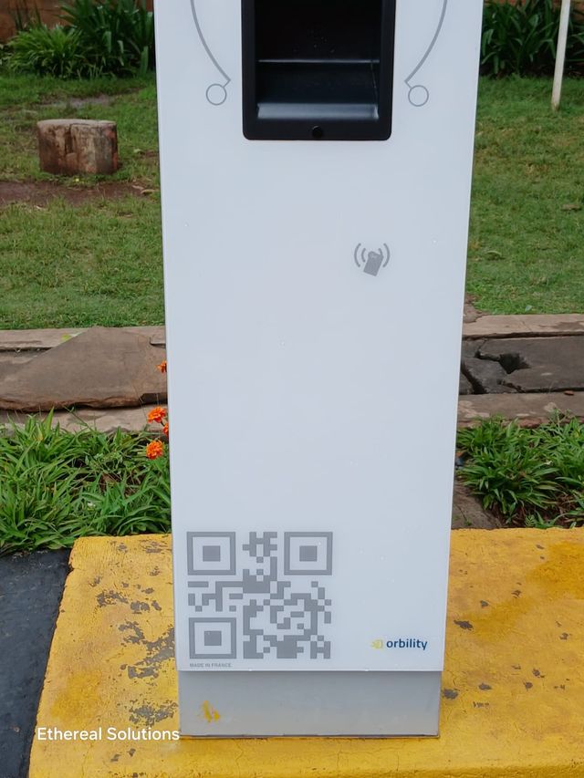 Detail of a parking terminal ticket slot, contactless card reader and QR code panel