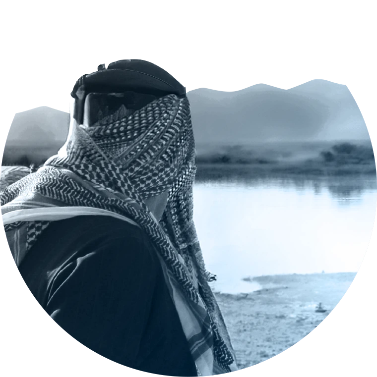 Image of a man looking in the distance over a lake
