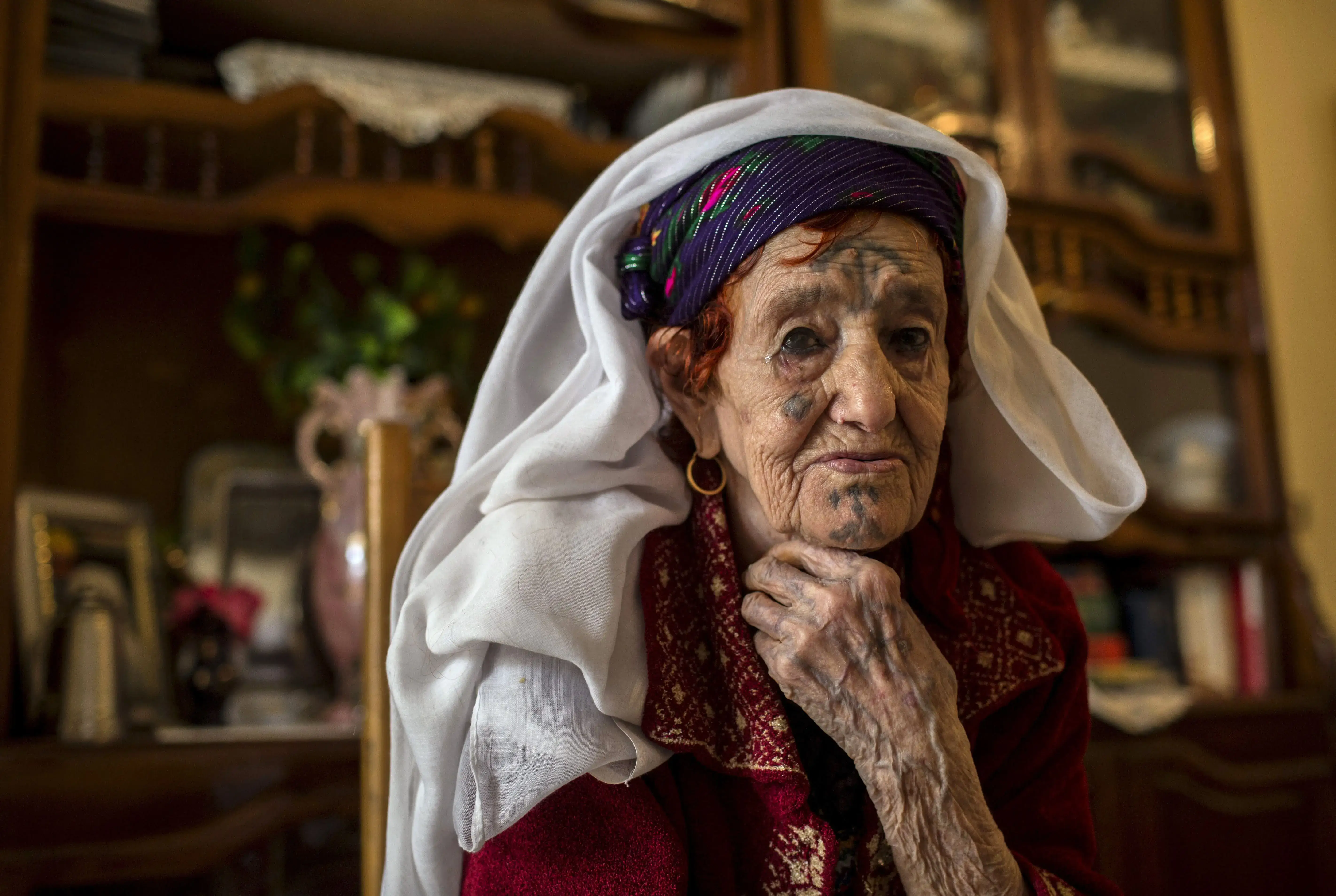 Older lady with tattoos on her face and hands