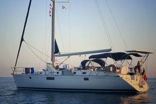 Cruising sailboat at anchor with its bimini