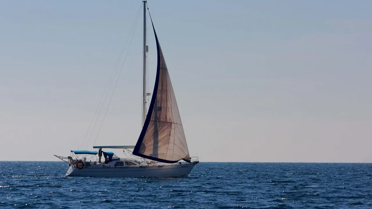 Sailboat under sail on a calm sea in fine weather