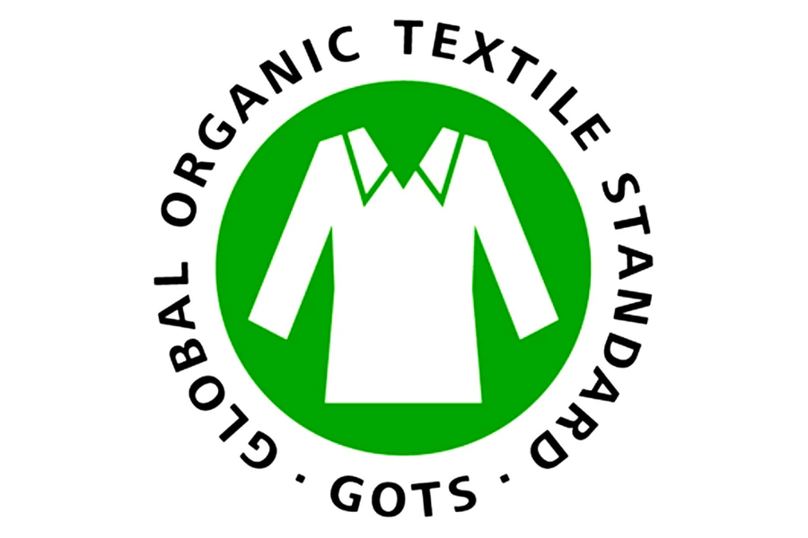 A green and white certification logo with a stylized shirt icon in the center, encircled by the words 'GLOBAL ORGANIC TEXTILE STANDARD • GOTS •'.