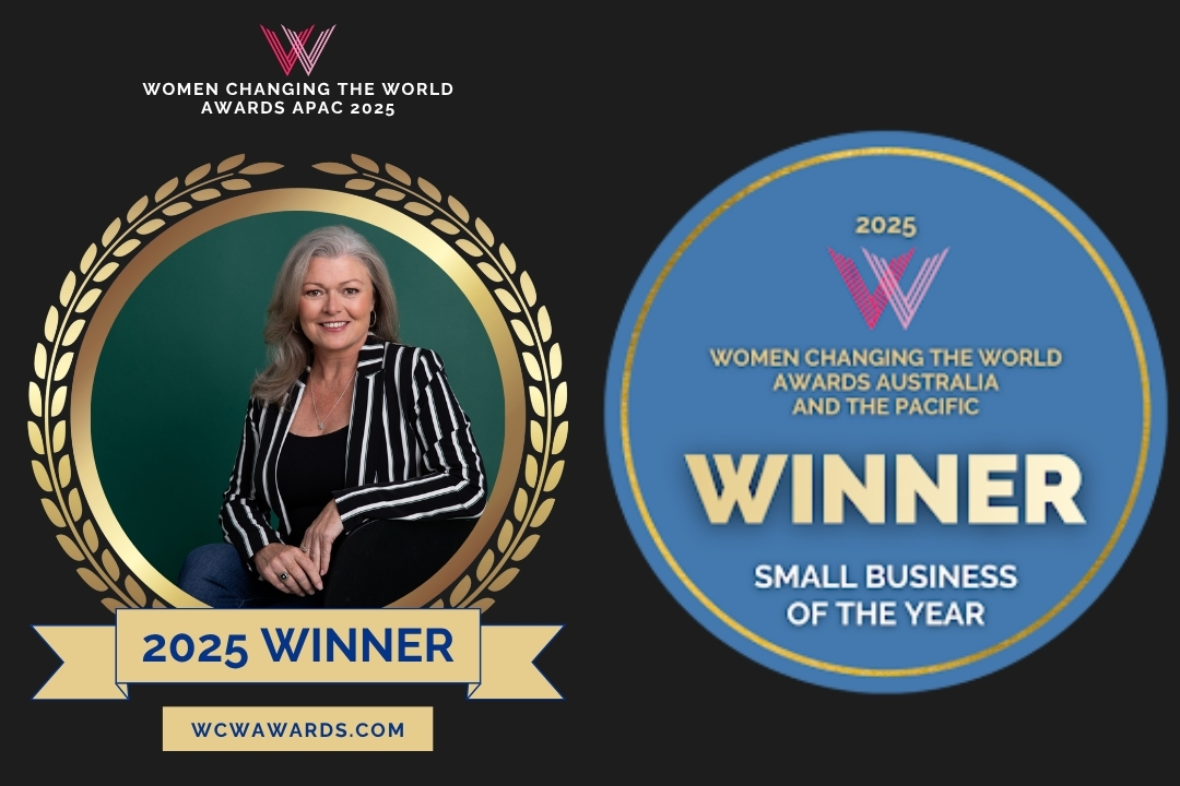 Emma from Expressions Fundraising, winner of the 2025 Women Changing the World Awards APAC, standing confidently in front of a winner’s banner wearing a green jacket.