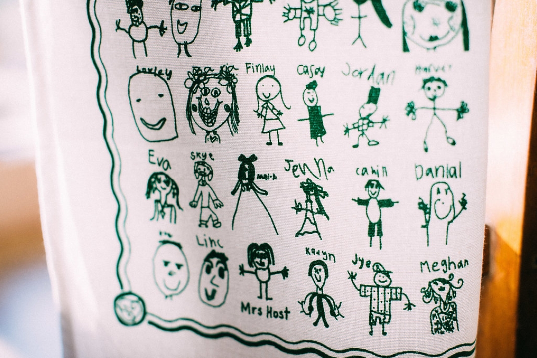 Hanging screen printed fundraising tea towel with children's drawings
