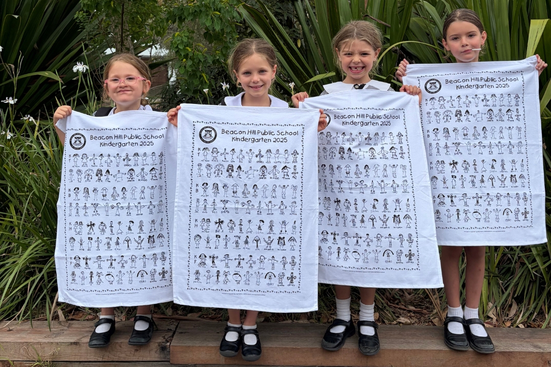 Happy school children with their fundraising kindergarten tea towels