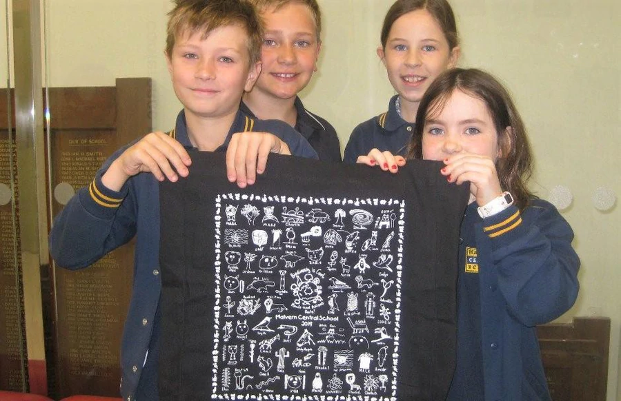 Malvern Central School students proudly holding their biodiversity fundraiser tote bag created with Expressions Australia.