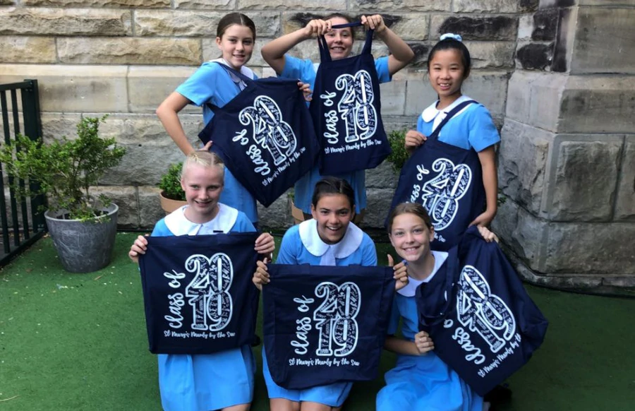 Year 6 students from St Mary’s Manly holding Expressions tote bags with “Class of 2019” design.