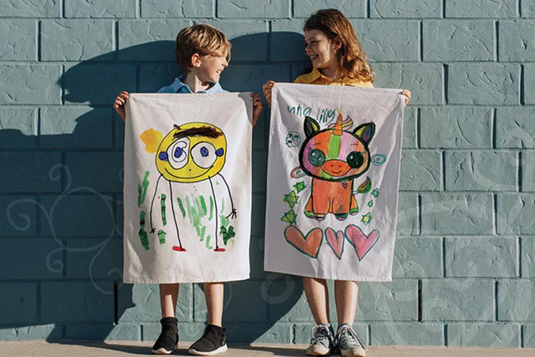 Digital printed school tea towels fundraising display holding by 2 kids
