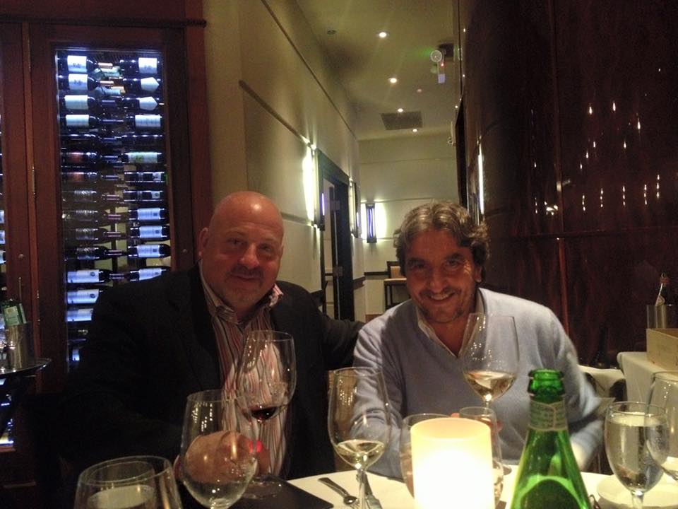 A scenic view of a rolling Italian countryside with vineyards.