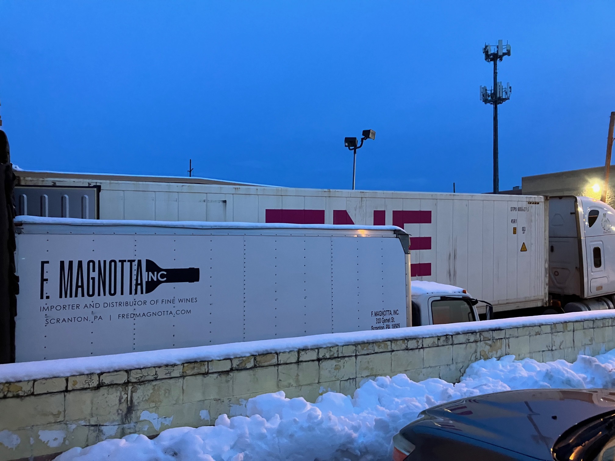 A truck delivers a container of wine early in the morning