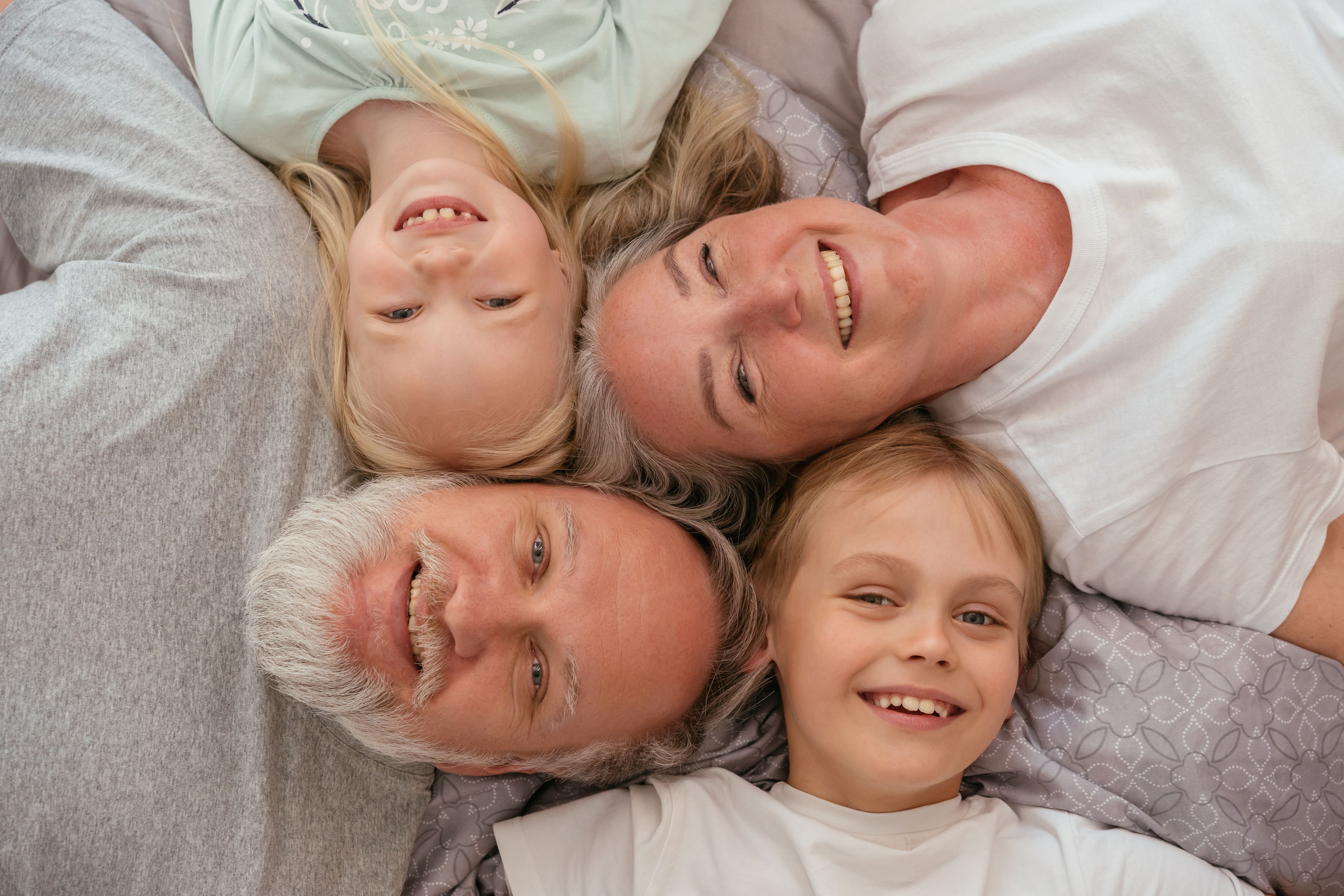 Three generations of a family smiling together