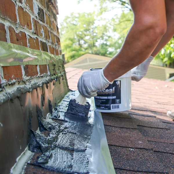 New metal flashing where a chimney meets a roof.