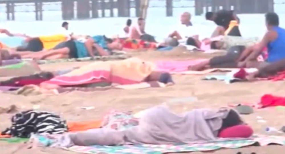 वायरल वीडियो में लोग भीषण गर्मी से बचने के लिए मुंबई के वर्सोवा बीच पर सोते हुए दिखे