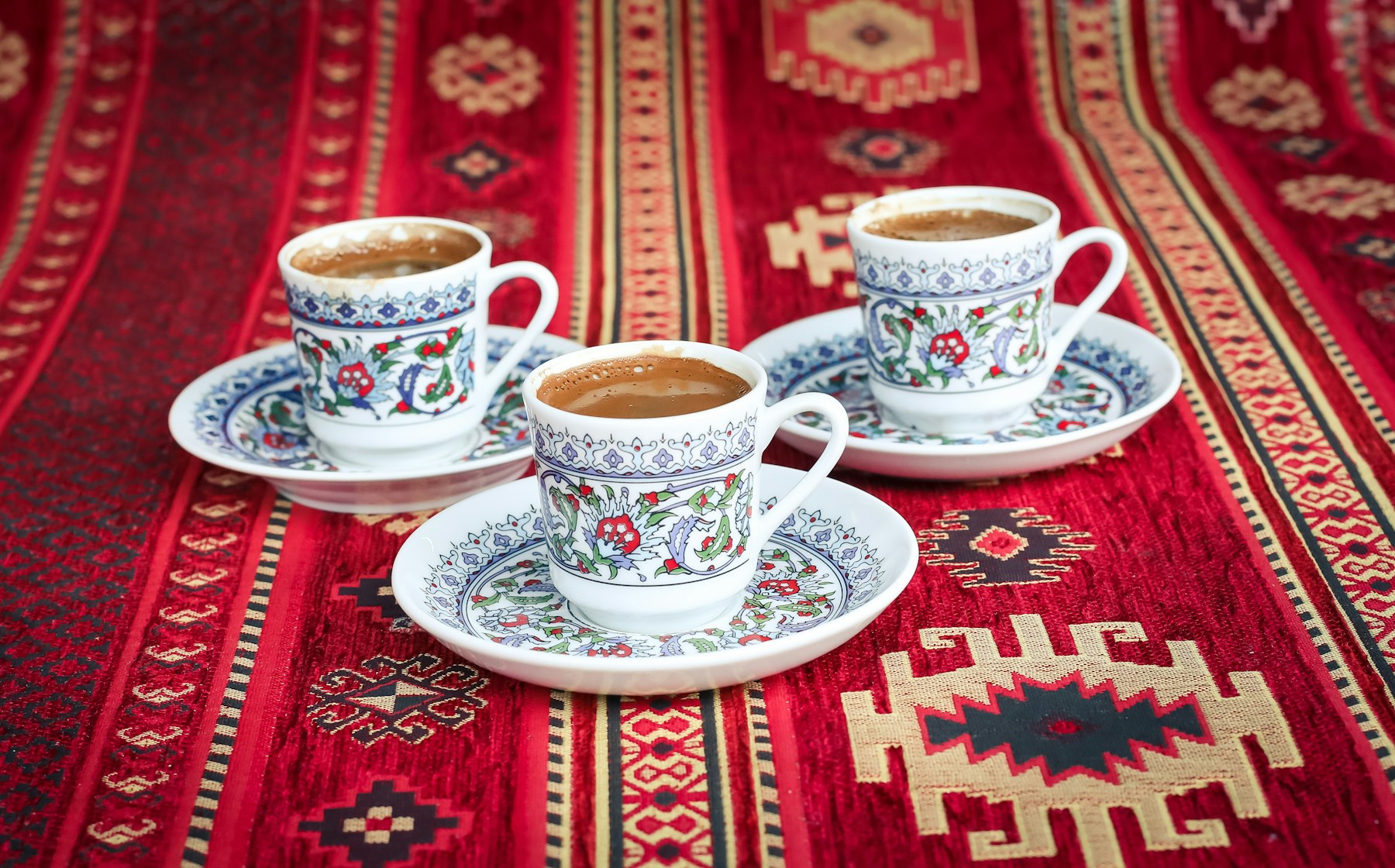 Three cups of coffee on a kilim