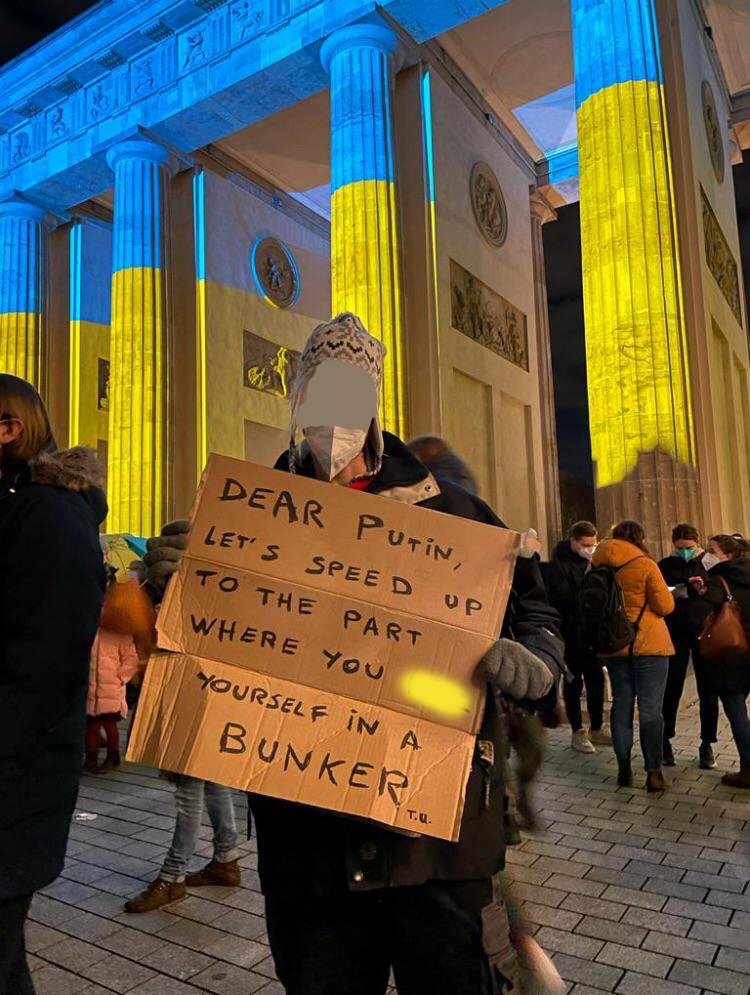 Demonstrator holding a sign in protest to the invasion of Ukraine.