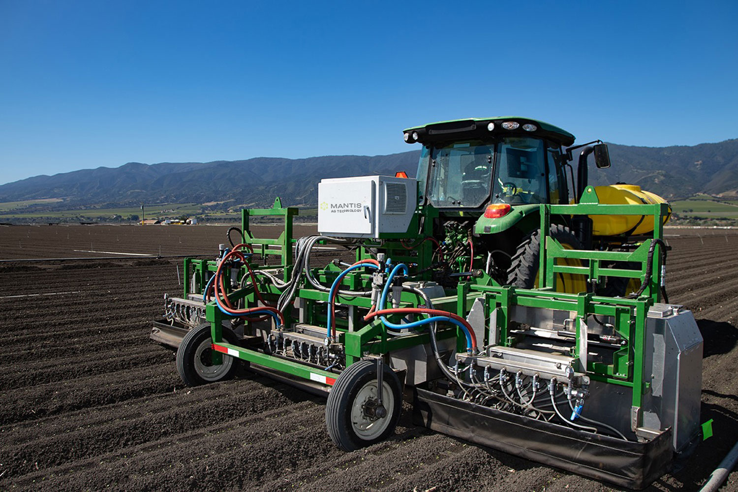 An automated Mantis thinner machine operating in a lettuce field, showcasing agricultural technology.