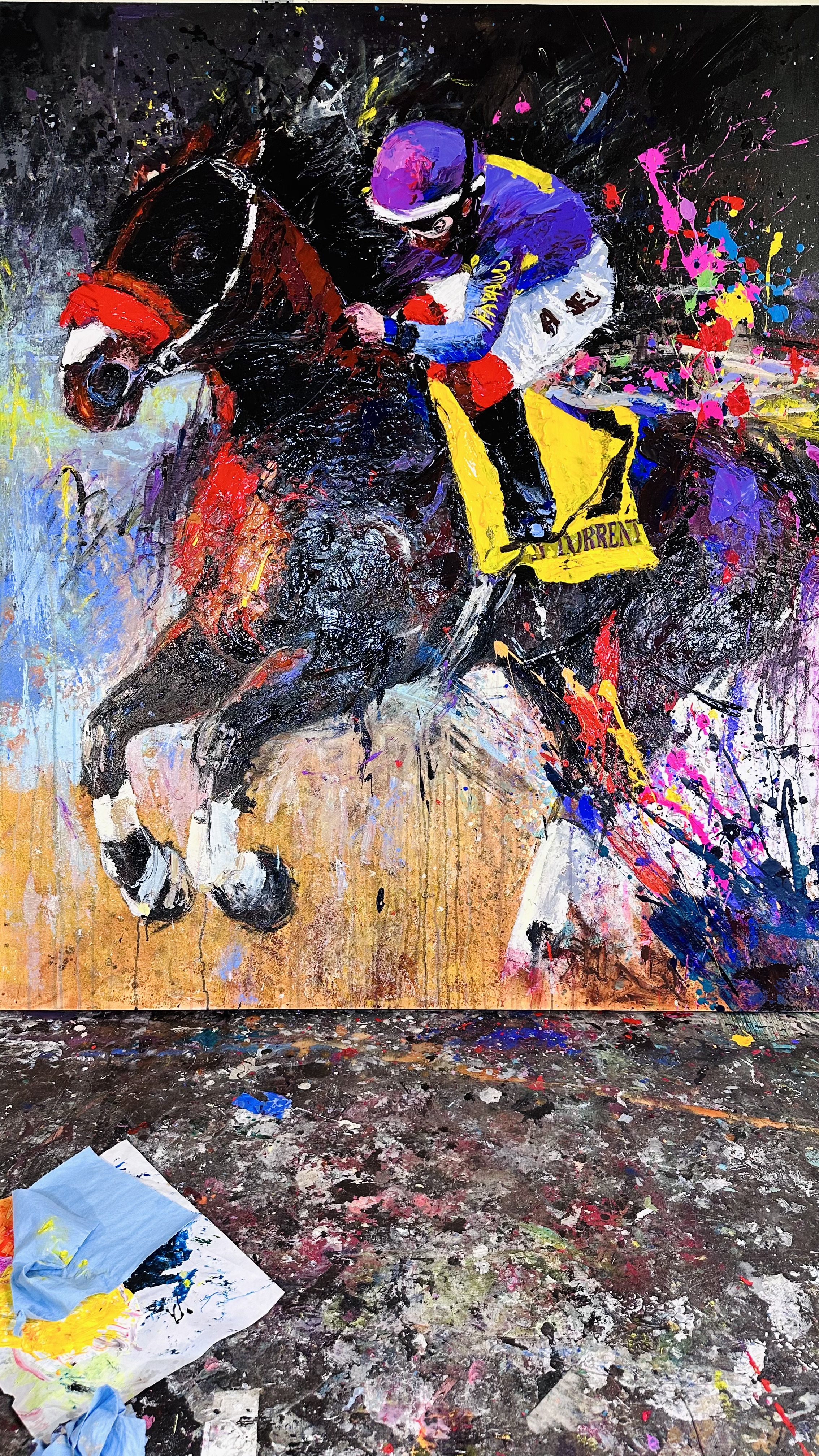 The finished Raging Torrent canvas by Gabrielle Benot standing on a paint-spattered studio floor, the jockey in purple and the horse in deep red and black.