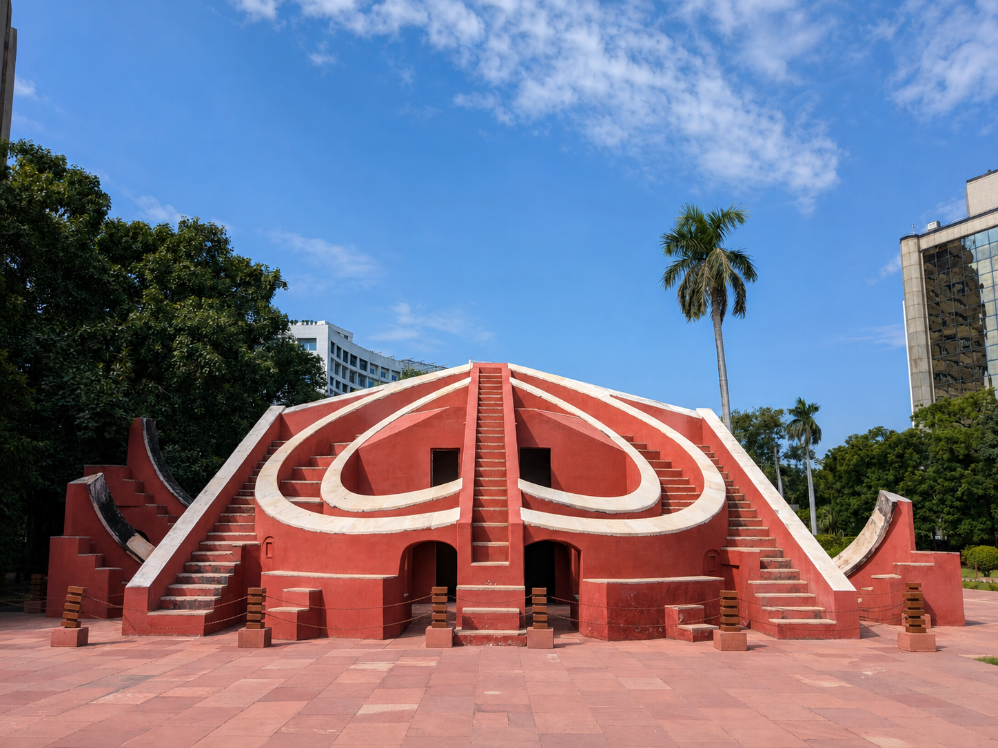 The curving red and white geometry of an instrument at Jantar Mantar