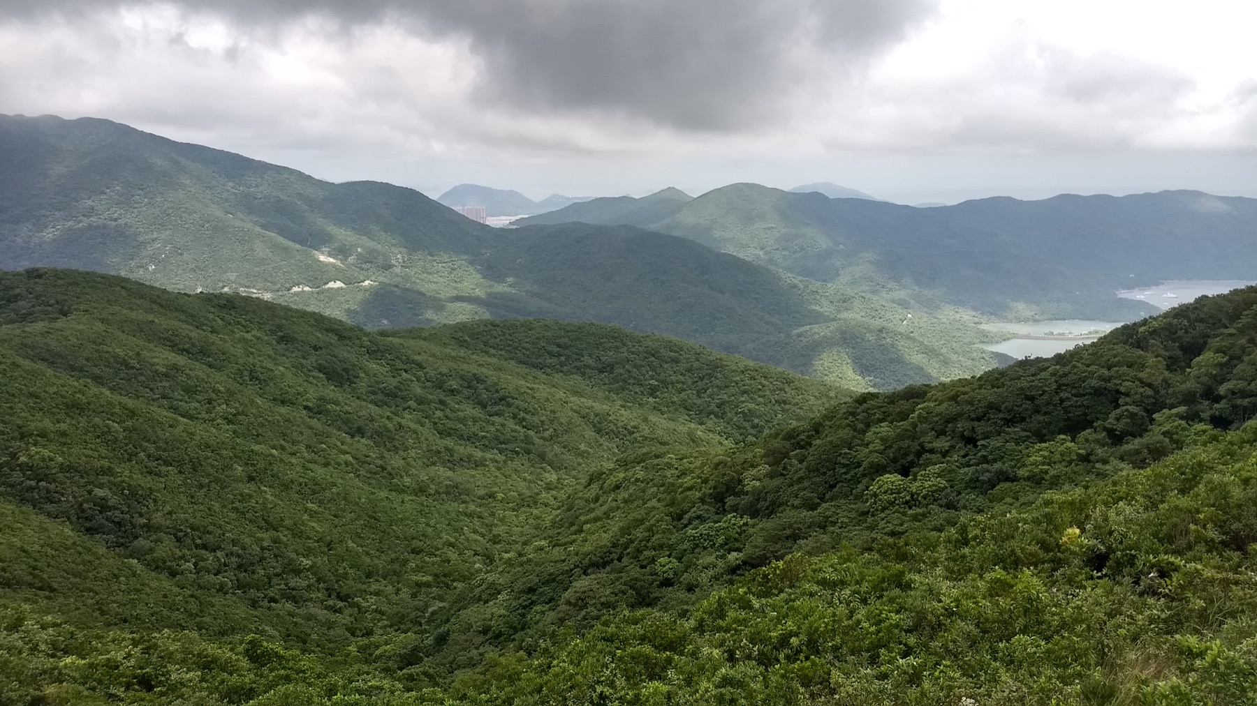 Historic waterworks and green hills at Tai Tam Reservoir