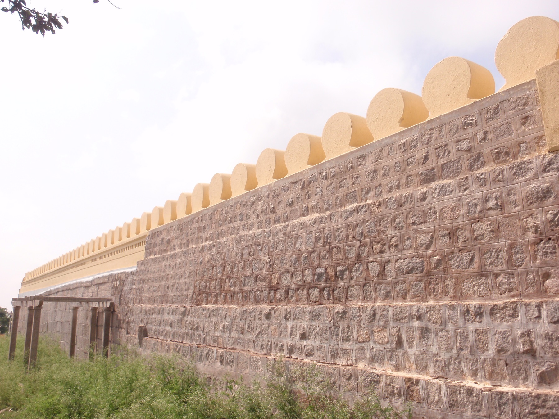 A long masonry wall along a Mysuru avenue