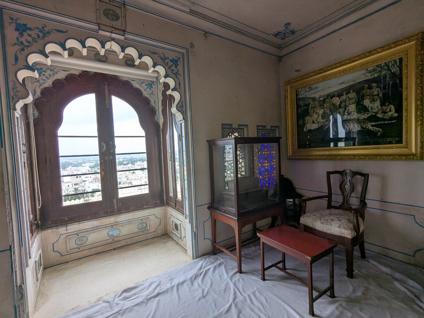 A decorated window framing the city from City Palace