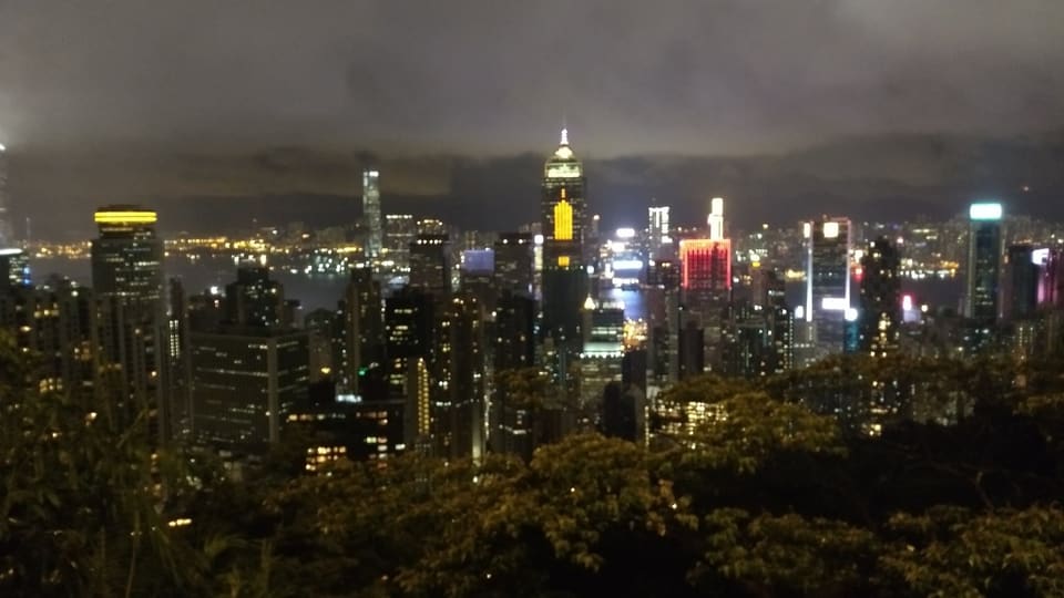 Hong Kong's illuminated skyline and harbour seen from The Peak at night