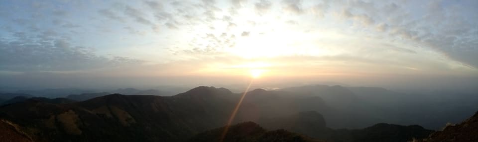 Sunrise over layered mountain ridges at Kodachadri