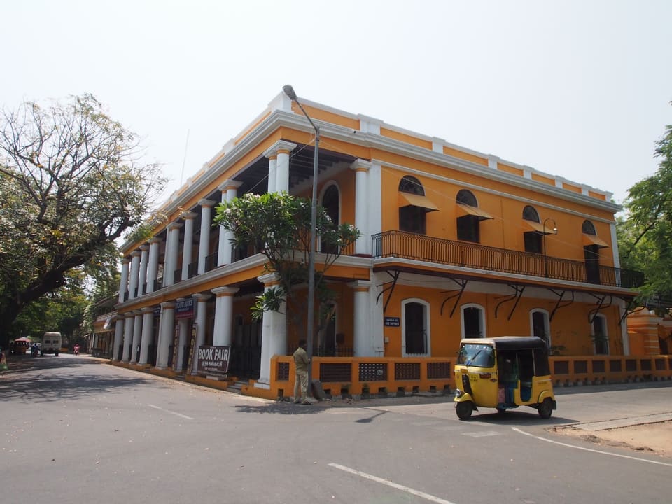 Yellow heritage façade and auto rickshaw on a Puducherry street