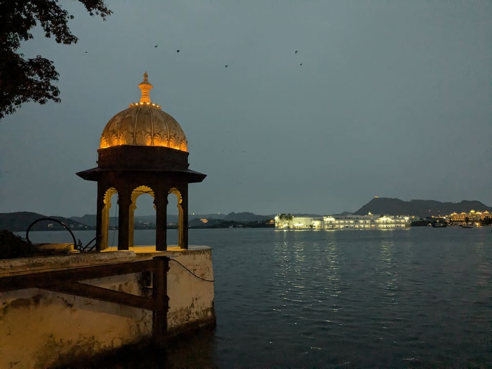 Lake Pichola and illuminated palaces at night in Udaipur
