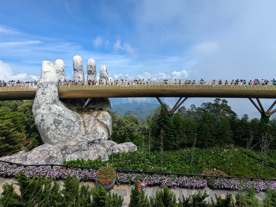 The Golden Bridge at Ba Na Hills held by giant stone hands