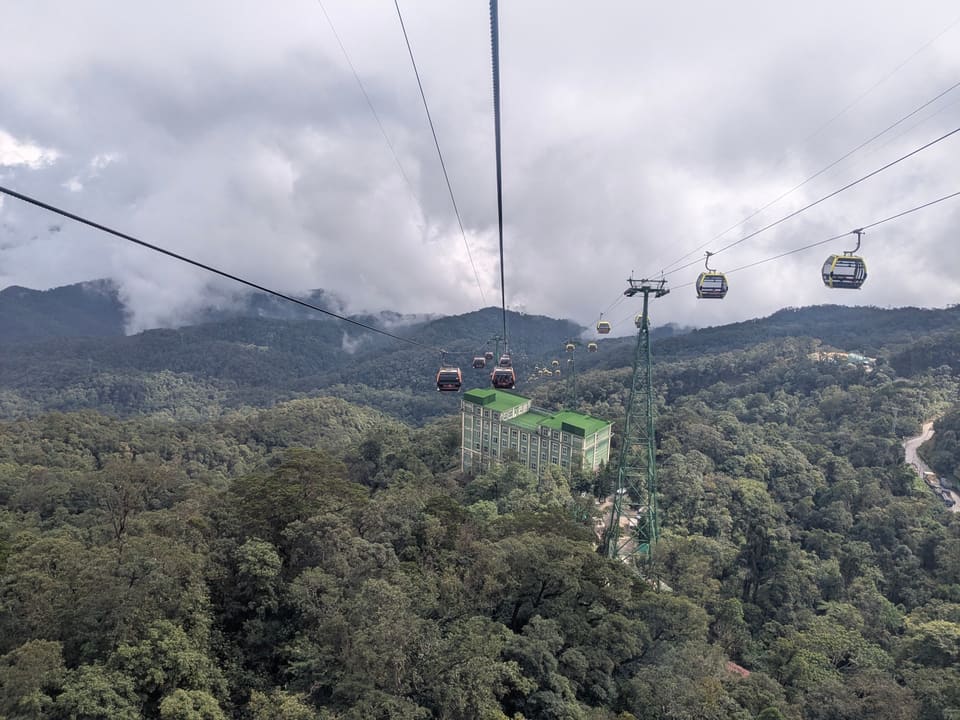 Cable cars crossing a forested valley at Ba Na Hills