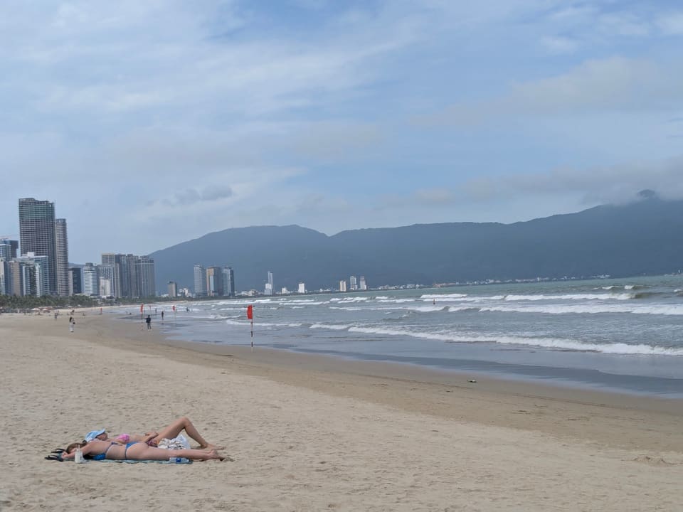Wide beach in Da Nang with mountains beyond the shoreline